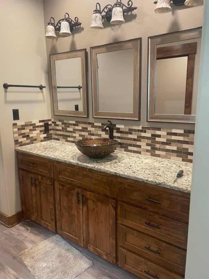 Mosaic tile bathroom backsplash with granite countertop installed by Heart of Texas Flooring